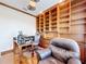 Spacious home office with built-in shelving, hardwood floors, and a comfortable work space at 9347 Se 137Th Street Rd, Summerfield, FL 34491