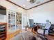 Bright home office featuring french doors, built-ins, and hardwood floors at 9347 Se 137Th Street Rd, Summerfield, FL 34491