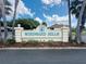 Community sign for Windward Hills entrance surrounded by palm trees at 9347 Se 137Th Street Rd, Summerfield, FL 34491