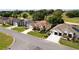 Street view of single-story homes with well-manicured lawns and driveways at 9347 Se 137Th Street Rd, Summerfield, FL 34491