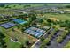 Community aerial view showcasing tennis, baseball, and pickleball courts, plus a residential neighborhood at 9388 Sw 53Rd Pl, Ocala, FL 34481