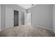 Bedroom featuring carpet, an open closet, and a view leading to another room through a white door at 9388 Sw 53Rd Pl, Ocala, FL 34481