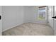 Neutral bedroom featuring carpet, a window offering natural light, and a closet door on the side at 9388 Sw 53Rd Pl, Ocala, FL 34481