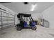 Spacious garage featuring an electric golf cart, epoxy floors, and water filtration system at 9388 Sw 53Rd Pl, Ocala, FL 34481