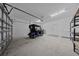 Large garage featuring an electric golf cart, epoxy floors and extra storage shelves at 9388 Sw 53Rd Pl, Ocala, FL 34481