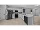 Well-lit kitchen features stainless steel appliances, white cabinets and breakfast bar seating at 9388 Sw 53Rd Pl, Ocala, FL 34481