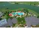Aerial view of a beautiful community pool with lake and landscaping at 9388 Sw 53Rd Pl, Ocala, FL 34481