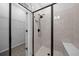 Contemporary tiled shower with a glass enclosure, a showerhead, and bench seating at 9388 Sw 53Rd Pl, Ocala, FL 34481