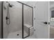 Contemporary tiled shower with a glass enclosure, a showerhead, and bench seating at 9388 Sw 53Rd Pl, Ocala, FL 34481