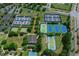 Aerial view of several well-maintained community tennis courts at 9388 Sw 53Rd Pl, Ocala, FL 34481