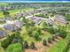 Community aerial showcasing well-maintained homes, lush landscaping and green spaces at 9740 Sw 68Th Ln, Ocala, FL 34481