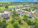 Residential aerial showcasing community landscaping, waterways and mature trees at 9740 Sw 68Th Ln, Ocala, FL 34481