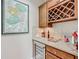 Elegant bar area with granite countertop, wine storage, and decorative Ireland map at 9740 Sw 68Th Ln, Ocala, FL 34481