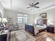 Comfortable bedroom with tray ceiling, wood floors, and ample natural light at 9740 Sw 68Th Ln, Ocala, FL 34481