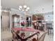 Elegant dining area featuring a chandelier, with views of the modern kitchen with black appliances at 9740 Sw 68Th Ln, Ocala, FL 34481