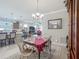 Open-concept dining area with chandelier that offers a view of the kitchen and living room at 9740 Sw 68Th Ln, Ocala, FL 34481