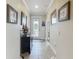 Grand foyer featuring tile flooring, decorative glass front door, and elegant decor at 9740 Sw 68Th Ln, Ocala, FL 34481