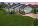 Charming home with a well-manicured lawn, beautiful landscaping, and a brick paver driveway at 9740 Sw 68Th Ln, Ocala, FL 34481