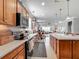 An inviting kitchen with an open floor plan offers ample counter space and stainless steel appliances at 9740 Sw 68Th Ln, Ocala, FL 34481