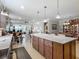 Spacious kitchen island featuring sleek countertops, ample storage, and pendant lighting at 9740 Sw 68Th Ln, Ocala, FL 34481