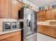 A modern kitchen with stainless steel refrigerator and ample cabinet space at 9740 Sw 68Th Ln, Ocala, FL 34481
