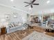 Open-concept living room with hardwood floors seamlessly connecting to the kitchen area at 9740 Sw 68Th Ln, Ocala, FL 34481