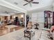 Open-concept living room with tile and wood flooring, ceiling fan, and neutral color palette at 9740 Sw 68Th Ln, Ocala, FL 34481