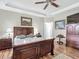 Main bedroom features tray ceiling, natural light, and traditional decor at 9740 Sw 68Th Ln, Ocala, FL 34481