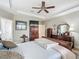 Serene main bedroom boasts a tray ceiling, wooden furniture, and a tranquil atmosphere at 9740 Sw 68Th Ln, Ocala, FL 34481