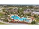 Aerial view of the community pool and lounging area surrounded by tropical palm trees at 9740 Sw 68Th Ln, Ocala, FL 34481
