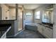 Bright bathroom with a double vanity, granite countertops, walk-in shower, and a soaking tub at 9934 Se 64Th Ave, Belleview, FL 34420