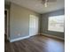 Bedroom featuring hardwood floors, a window and double door closet at 9934 Se 64Th Ave, Belleview, FL 34420