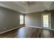 Bedroom features wood floors, a ceiling fan, and tray ceilings at 9934 Se 64Th Ave, Belleview, FL 34420