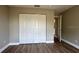Bedroom features hard surface floors and a closet with sliding doors at 9934 Se 64Th Ave, Belleview, FL 34420