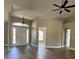 The foyer boasts gleaming hardwood floors and a modern chandelier at 9934 Se 64Th Ave, Belleview, FL 34420