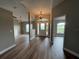 Spacious foyer with wood-look flooring, neutral walls, and an archway leading to other living spaces at 9934 Se 64Th Ave, Belleview, FL 34420