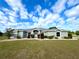 Charming single-story home boasts a manicured lawn, complemented by colorful landscaping and a welcoming entrance at 9934 Se 64Th Ave, Belleview, FL 34420
