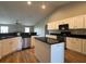 Bright kitchen features an island, granite countertops, and stainless steel appliances at 9934 Se 64Th Ave, Belleview, FL 34420