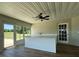 Enclosed lanai with ceiling fan, wet bar, white cabinets, and quartz countertops at 9934 Se 64Th Ave, Belleview, FL 34420