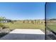 Spacious backyard featuring a lush green lawn with view of neighboring homes and a concrete patio at 10033 Sw 96Th St, Ocala, FL 34481