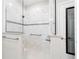 Elegant bathroom featuring a glass-enclosed shower with marble tile and a convenient grab bar for accessibility at 10033 Sw 96Th St, Ocala, FL 34481