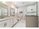 Well-lit bathroom with dual sinks, a glass-enclosed shower, and white marble accents, offering a spa-like experience at 10033 Sw 96Th St, Ocala, FL 34481