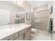 Bright bathroom featuring a double sink vanity and a shower with glass door, creating a modern and functional space at 10033 Sw 96Th St, Ocala, FL 34481