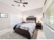 Cozy bedroom featuring a comfortable bed, ceiling fan, and closet, creating a relaxing retreat at 10033 Sw 96Th St, Ocala, FL 34481