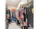 Walk-in closet with ample storage space and organized clothing racks, providing a practical storage solution at 10033 Sw 96Th St, Ocala, FL 34481