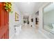 Welcoming foyer with elegant marble floors, a glass table, and views into the living spaces at 10033 Sw 96Th St, Ocala, FL 34481