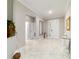 Bright foyer featuring marble floors, a decorative table, and a view into the living areas at 10033 Sw 96Th St, Ocala, FL 34481