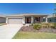 Inviting one-story home with a landscaped front yard and attached two-car garage at 10033 Sw 96Th St, Ocala, FL 34481