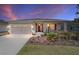 Charming home featuring a well-maintained front yard, two-car garage and a welcoming front porch at 10033 Sw 96Th St, Ocala, FL 34481