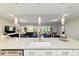 Close-up of the kitchen island featuring a sink, seating, and overlooking the living and dining areas at 10033 Sw 96Th St, Ocala, FL 34481